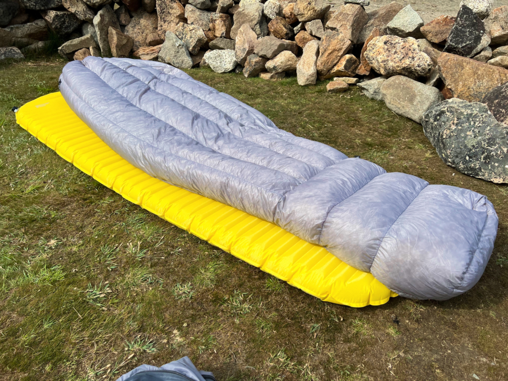 HMG 20 Degree Quilt on a yellow sleeping pad in the grass