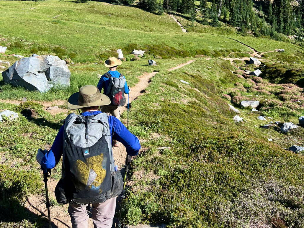 backpacking through a meadow with challenge ultra fabric packs