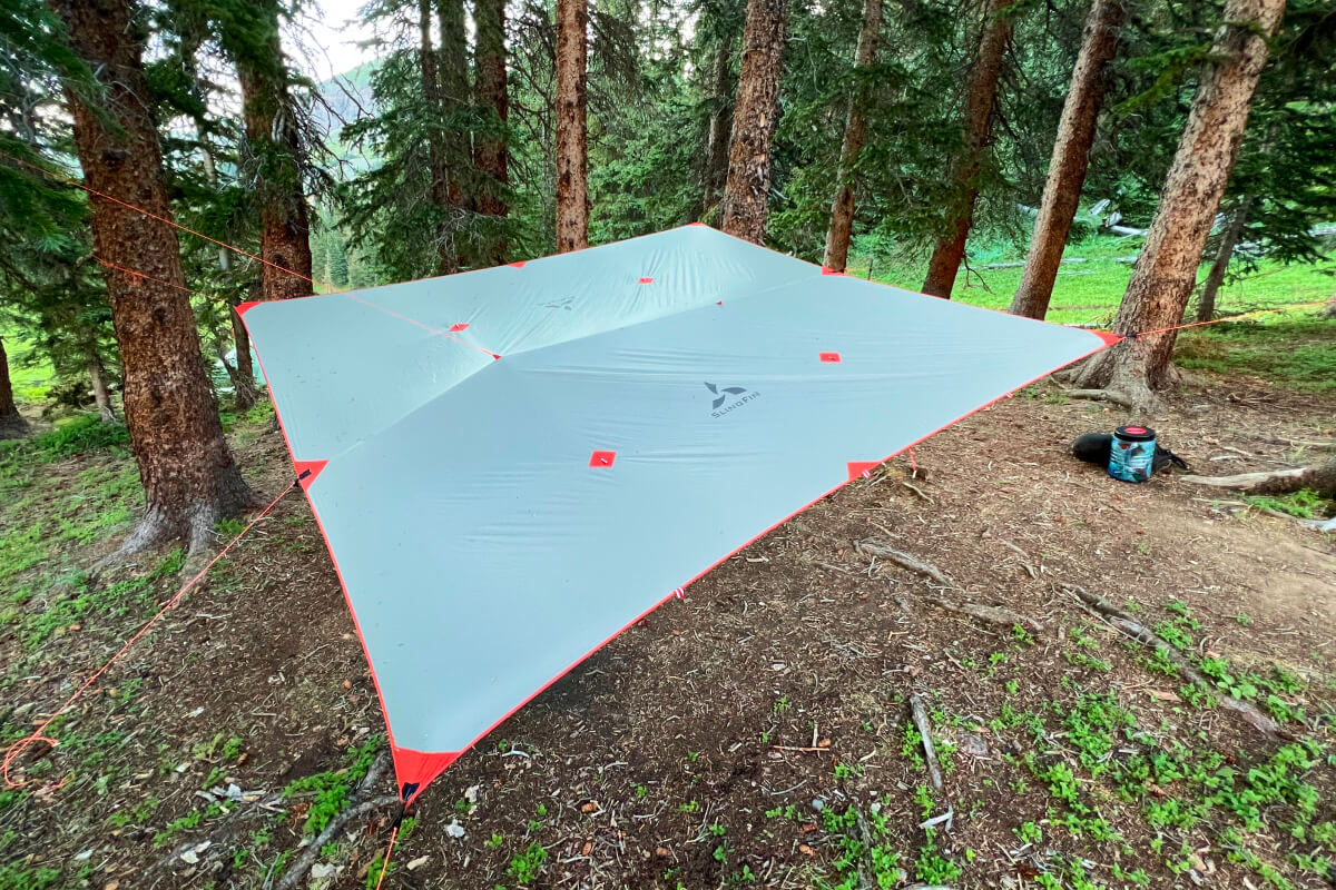tarp pitched at a campsite in the forest