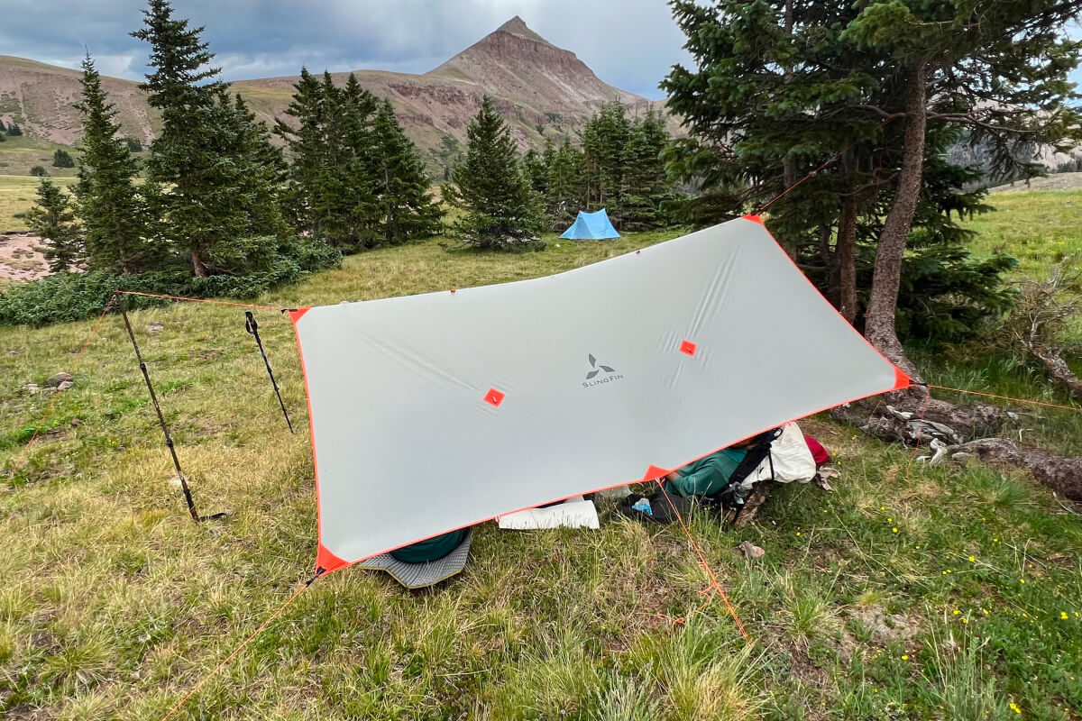 side view of slingfin tarp pitched in front of mountain