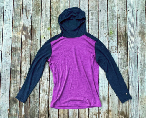 a merino wool hoodie base layer in purple by smartwool
