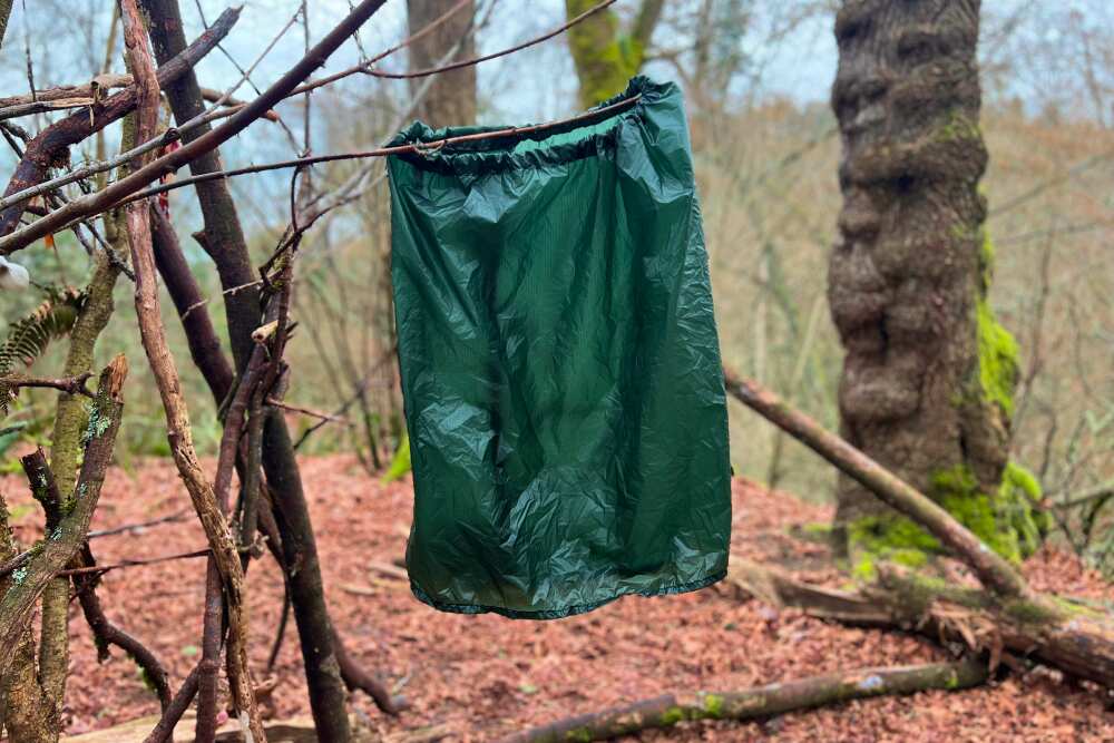 a waterproof wrap draped from a branch