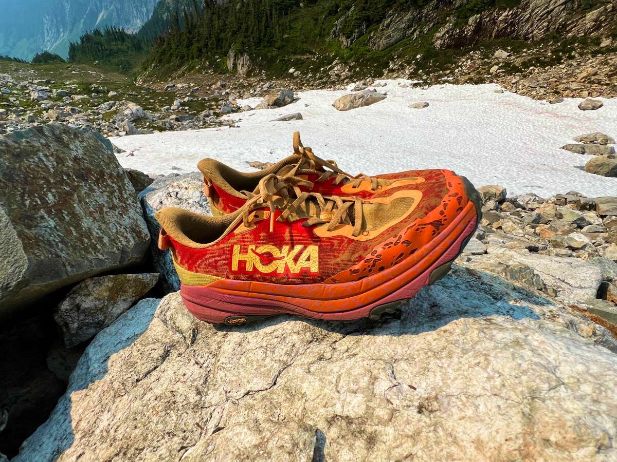 HOKA Speedgoat 6 trail running shoes on rocky terrain