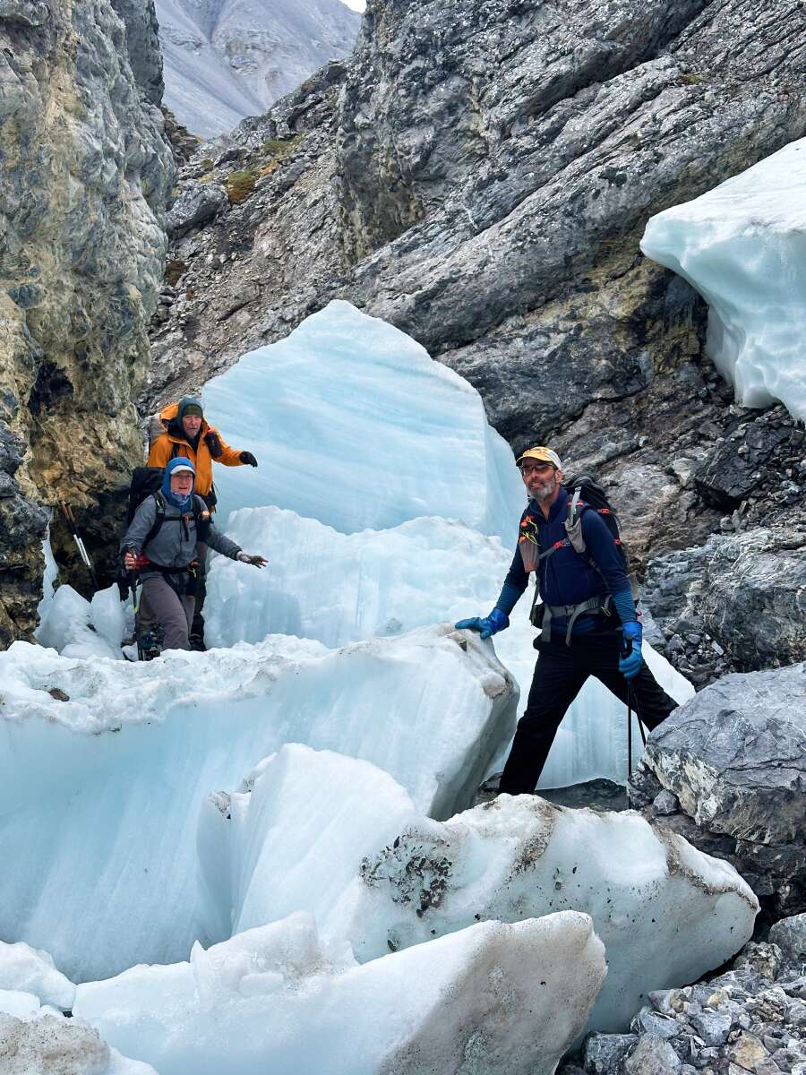lingering snow and ice hikers on lingering snow and ice on rock in alaska
