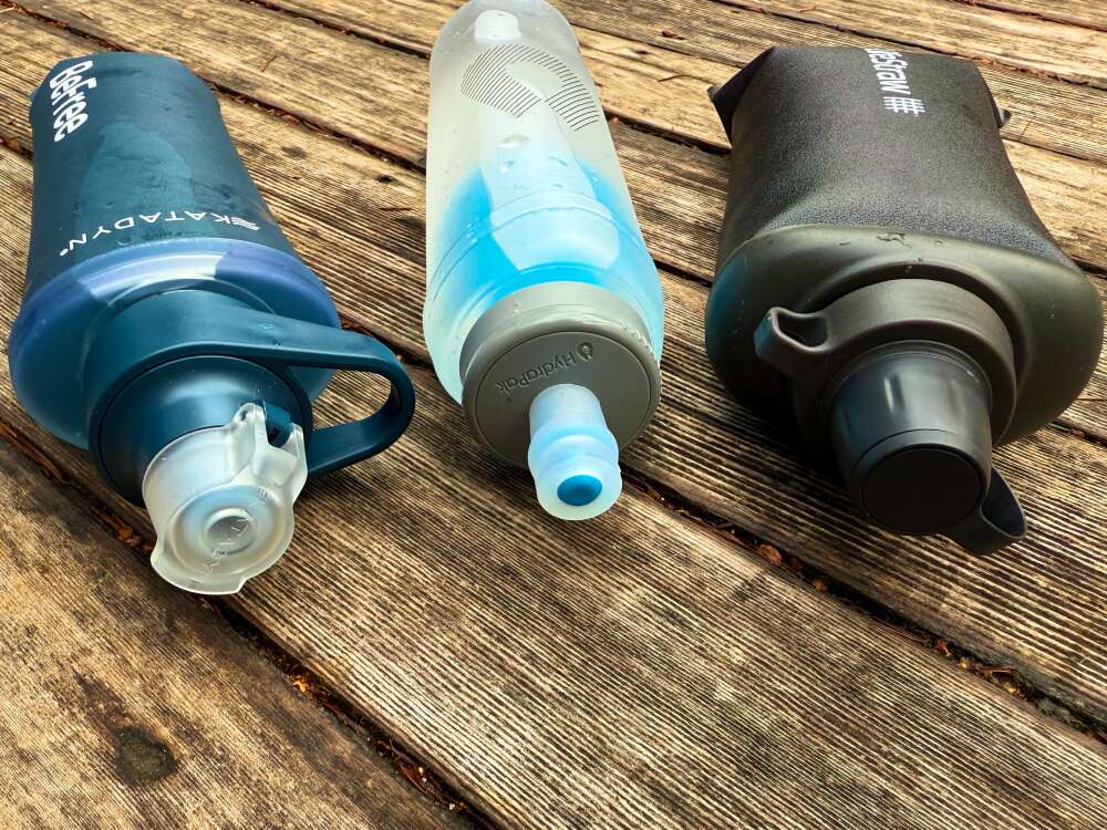 Katadyn BeFree vs HydraPak UltraFlask vs LifeStraw Peak Squeeze-2 front sides of the three best soft flask squeeze filters Katadyn BeFree vs HydraPak UltraFlask vs LifeStraw Peak Squeeze side by side, close up on caps