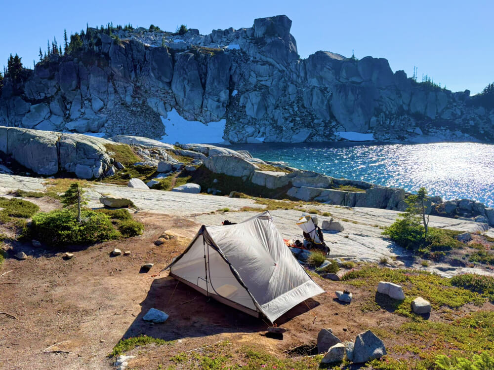 Gossamer Gear The Two Ultralight Tent next to a lake Gossamer Gear The Two Ultralight Tent next to a lake