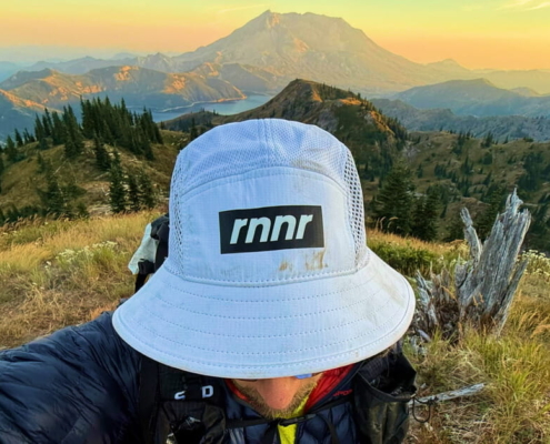 wearing one of the best runner bucket hats in front of mount st helens.