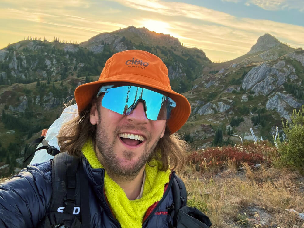 Best Bucket Hats for Running and Hiking wearing orange Ciele bucket hat for hiking and running